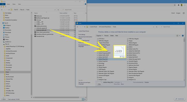 Dragging a font file from a downloads folder into the Font folder in Windows 10.