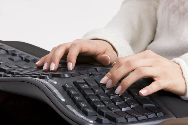 hands typing on ergonomic keyboard