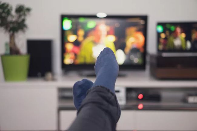 Person watching TV with feet up