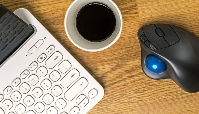 A trackball mouse with a tablet and keyboard