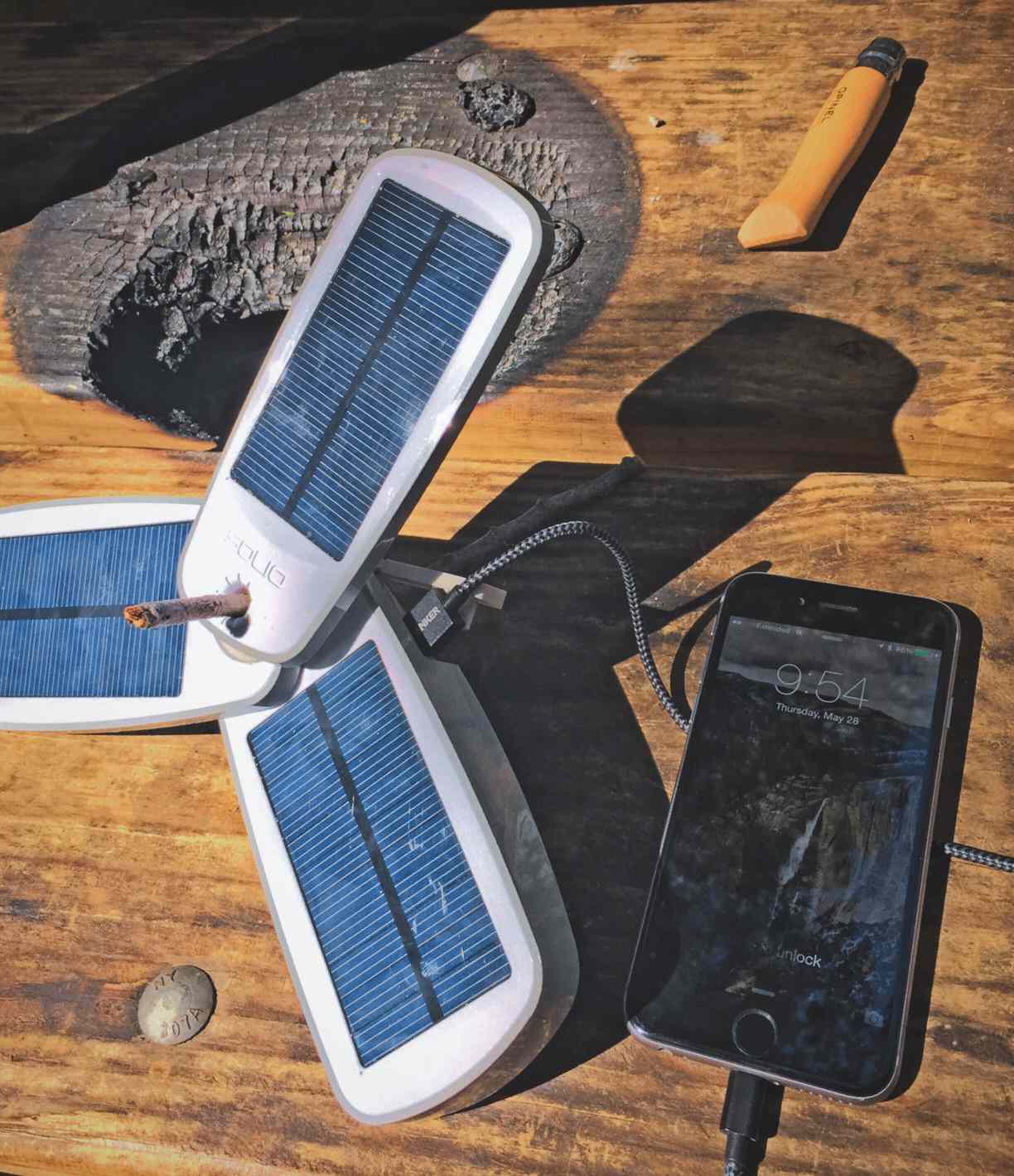 An iPhone charging via solar power